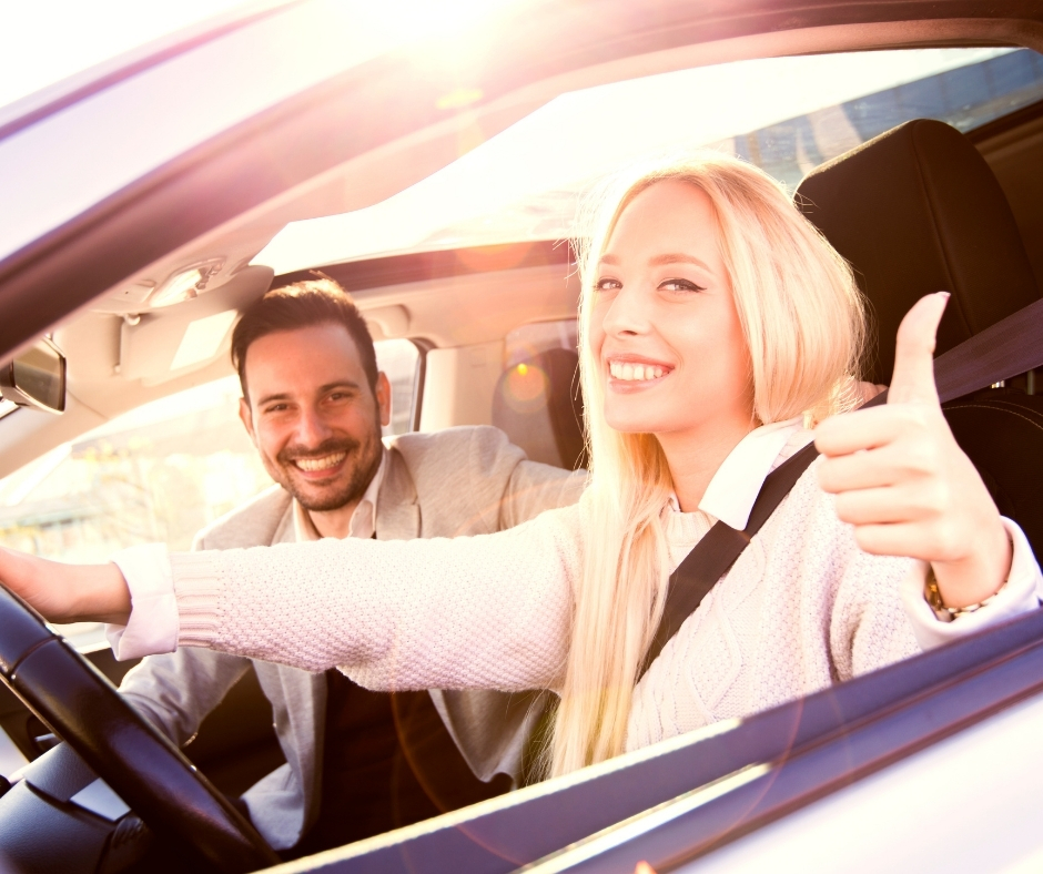 Happy couple driving in their new or used vehicle. Get your Auto Loan with BlueOx Credit Union.