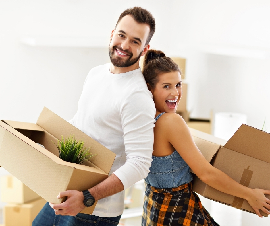 Young and happy couple moving into their new home as first-time homebuyers.