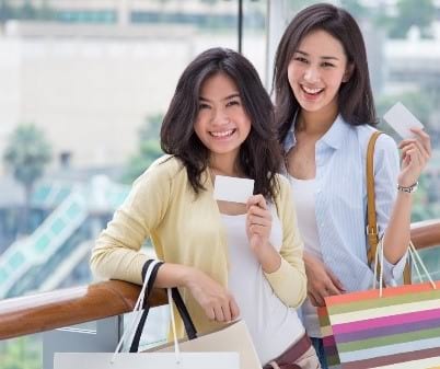 Friends shopping together with their credit cards. 