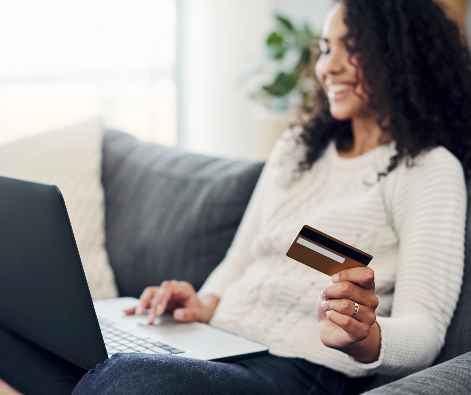 Woman online shopping with her debit card. 