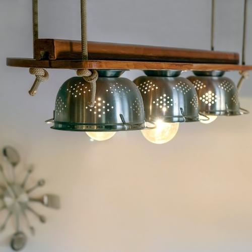 A wood light fixture hanging from a ceiling 